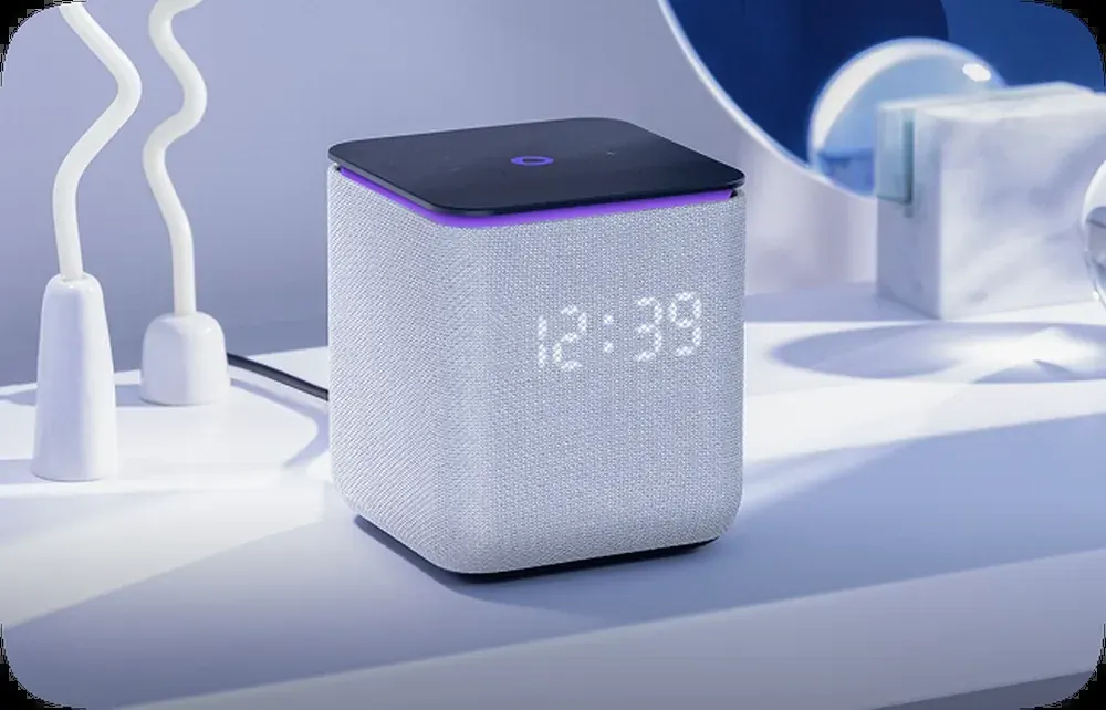 Compact smart speaker with clock display on a desk in a UAE home setting Compact smart speaker with clock display on a desk in a UAE home setting
